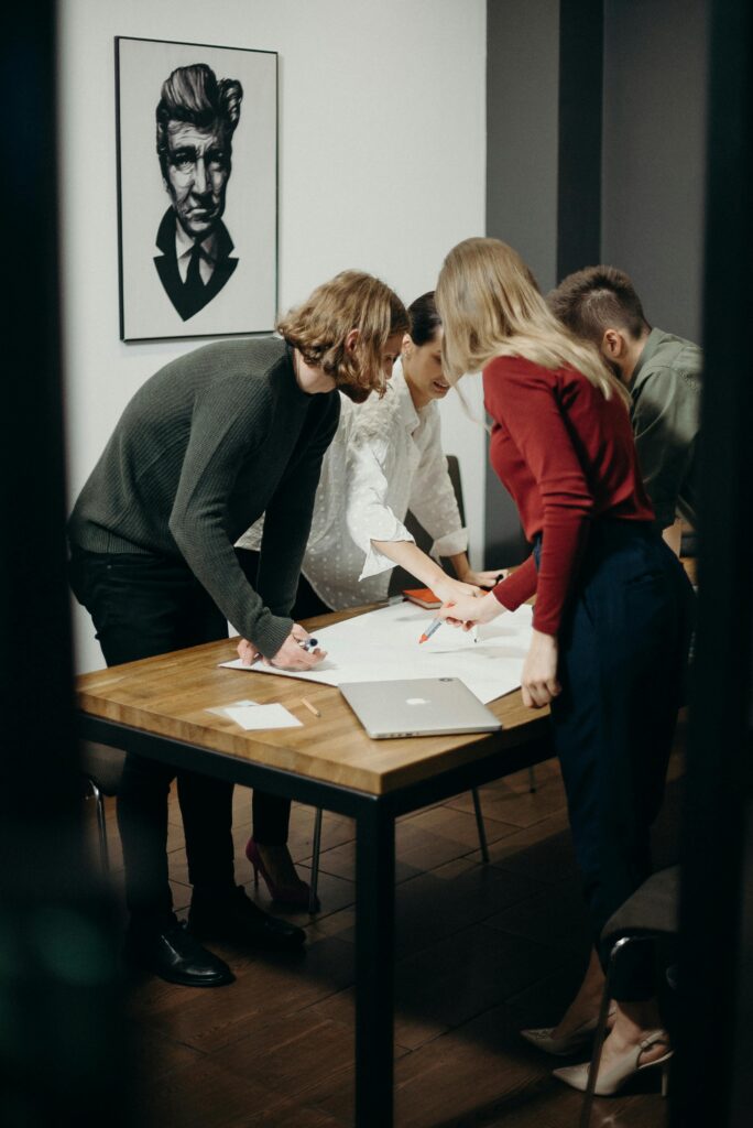 pexels-photo-3205568-3205568 Group of diverse professionals brainstorming ideas in a stylish modern office space.